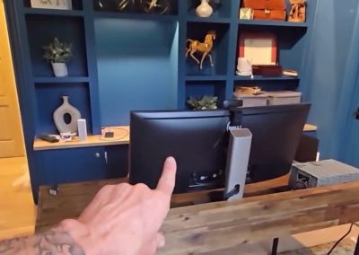 Blue built-in office shelving before styling with monitors, desk, and decorative accessories