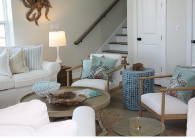 Luxury coastal-inspired living room with layered textures, woven accents, and soft neutral furnishings