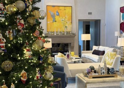 Luxury Christmas tree in a colorful living room with gold ornaments and elegant holiday decor