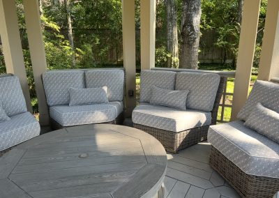 Luxury outdoor patio transformation with custom patterned cushions, woven seating, and elegant outdoor styling