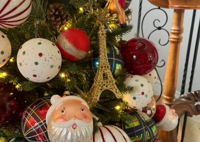 Whimsical Christmas tree with plaid, striped, Santa, and Eiffel Tower ornaments