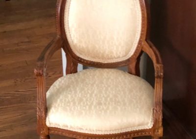 Vintage wood armchair before refresh with cream upholstery and carved frame
